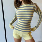 Person wearing a yellow and gray striped long-sleeve top and shorts against a white background